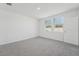 Neutral bedroom featuring plush carpeting, ample natural light from two windows, and a spacious closet at 1861 Brekey Way, Zephyrhills, FL 33541