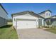Charming single-story home with a well-manicured lawn, a two-car garage, and inviting curb appeal at 1861 Brekey Way, Zephyrhills, FL 33541