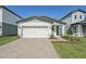 Charming single Gathering home features a paver driveway and a two-car garage at 1861 Brekey Way, Zephyrhills, FL 33541