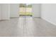 Bright living space with wood-look floors and sliding glass doors leading to a private backyard at 1861 Brekey Way, Zephyrhills, FL 33541