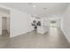 Open-concept living space features modern flooring, an island kitchen, and stainless steel appliances at 1861 Brekey Way, Zephyrhills, FL 33541