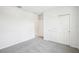 Cozy bedroom with carpet flooring, ample natural light, and a closet with white doors at 1870 Draughton Dr, Zephyrhills, FL 33541