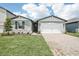 Charming single-story home with a well-manicured lawn and a two-car garage at 1870 Draughton Dr, Zephyrhills, FL 33541