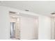 Hallway with an arched doorway to a carpeted room, white doors, and recessed lighting at 1870 Draughton Dr, Zephyrhills, FL 33541
