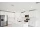 Modern kitchen featuring stainless steel appliances, an island and white cabinetry at 1870 Draughton Dr, Zephyrhills, FL 33541