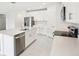 Well-lit kitchen boasting stainless steel appliances, white cabinets, and a large island at 1870 Draughton Dr, Zephyrhills, FL 33541