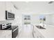 Modern kitchen featuring white cabinets, a central island, and stainless steel appliances at 1870 Draughton Dr, Zephyrhills, FL 33541