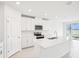 Bright kitchen with stainless steel appliances, large island and sliding glass doors at 1870 Draughton Dr, Zephyrhills, FL 33541