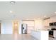 Open living space with modern kitchen, stainless appliances and bright tile flooring at 1870 Draughton Dr, Zephyrhills, FL 33541