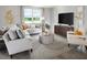 Cozy living room with comfortable seating, large windows, and stylish furnishings at 233 Lazy Shore Dr, Nokomis, FL 34275
