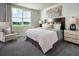 Serene bedroom featuring soft natural light, a large window, and neutral decor at 233 Lazy Shore Dr, Nokomis, FL 34275