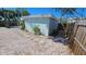 A private backyard featuring shell landscaping, stepping stones, and perimeter fencing at 280 46Th Ave, St Pete Beach, FL 33706