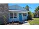 A charming single-story home features blue paint and a bright blue front door, complemented by fresh landscaping at 280 46Th Ave, St Pete Beach, FL 33706
