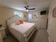 Bright bedroom with white furniture, ceiling fan, and adjoining bathroom at 280 46Th Ave, St Pete Beach, FL 33706