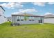 Well maintained backyard with lush green grass and newly planted tree at 31643 Wild Grape Ln, Brooksville, FL 34602