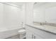 Bright bathroom featuring granite countertops, white cabinets, and a shower-tub combo at 31643 Wild Grape Ln, Brooksville, FL 34602
