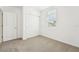 Bedroom with carpet, a window with blinds, and closet at 31643 Wild Grape Ln, Brooksville, FL 34602