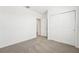 Bedroom with carpet, closet and door to another room at 31643 Wild Grape Ln, Brooksville, FL 34602