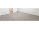 Spacious bedroom with plush gray carpeting and white trim throughout at 31643 Wild Grape Ln, Brooksville, FL 34602