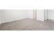 Cozy bedroom featuring neutral carpet and a doorway to a hallway at 31643 Wild Grape Ln, Brooksville, FL 34602