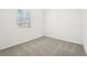 Bedroom with carpet, a window with blinds, and neutral walls at 31643 Wild Grape Ln, Brooksville, FL 34602