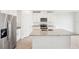Modern kitchen with stainless steel appliances and a granite island at 31643 Wild Grape Ln, Brooksville, FL 34602