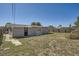 Large backyard with a neutral-colored home and a full fence for privacy and security at 3206 Peterborough St, Holiday, FL 34690