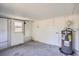 Unfinished basement with grey concrete floor and white painted walls, water heater, and access to backyard at 3206 Peterborough St, Holiday, FL 34690
