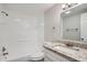 This full bathroom features a tub and shower combo, granite countertop and decorative hardware at 3206 Peterborough St, Holiday, FL 34690