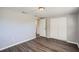 A bedroom features vinyl plank floors, a closet, and access to the bathroom at 3206 Peterborough St, Holiday, FL 34690
