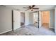 A spacious bedroom has a ceiling fan, closet, and doorway to the en-suite bathroom at 3206 Peterborough St, Holiday, FL 34690