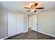 Bedroom featuring laminate flooring, a closet, and multiple doors at 3206 Peterborough St, Holiday, FL 34690