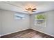 This bedroom has laminate floors, a ceiling fan, and large windows at 3206 Peterborough St, Holiday, FL 34690
