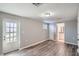 An expansive bonus room has vinyl floors, access to a bathroom, and an exterior door at 3206 Peterborough St, Holiday, FL 34690