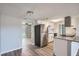 Modern kitchen featuring stainless steel appliances, white cabinetry, and granite countertops at 3206 Peterborough St, Holiday, FL 34690