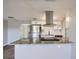 Kitchen with an island, granite counters, stainless appliances and white shaker style cabinets at 3206 Peterborough St, Holiday, FL 34690