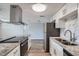 Modern kitchen featuring stainless steel appliances, white cabinetry, and granite countertops at 3206 Peterborough St, Holiday, FL 34690