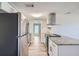 Modern kitchen featuring stainless steel appliances, white cabinetry, and granite countertops at 3206 Peterborough St, Holiday, FL 34690
