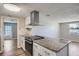Modern kitchen featuring stainless steel appliances, white cabinetry, and granite countertops at 3206 Peterborough St, Holiday, FL 34690