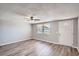 Bright living room featuring wood floors, a ceiling fan, neutral paint and a window at 3206 Peterborough St, Holiday, FL 34690