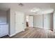 Bright living room features new wood floors, neutral paint, and access to kitchen, adding modern appeal at 3206 Peterborough St, Holiday, FL 34690