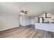 Open concept living room and kitchen with wood floors, neutral paint and stainless steel appliances at 3206 Peterborough St, Holiday, FL 34690