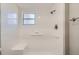 A tiled walk-in shower features a built-in seat, grab bars, and a showerhead at 3206 Peterborough St, Holiday, FL 34690
