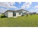 Expansive backyard with lush grass, a sliding glass door and a peaceful suburban setting at 3536 Moscato Dr, Brooksville, FL 34602