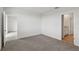 Neutral bedroom featuring plush carpet and an open doorway to the hallway at 3536 Moscato Dr, Brooksville, FL 34602