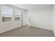 Cozy bedroom with plush carpeting, natural light and an open doorway at 3536 Moscato Dr, Brooksville, FL 34602