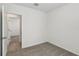 Bedroom featuring carpet, base trim, with an open doorway leading to a tiled room at 3536 Moscato Dr, Brooksville, FL 34602