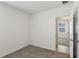 Neutral bedroom with plush carpeting and an open doorway to another room at 3536 Moscato Dr, Brooksville, FL 34602