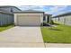 Charming home featuring a spacious driveway, two car garage and well-manicured front lawn at 3536 Moscato Dr, Brooksville, FL 34602