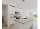 Bright, modern kitchen with granite countertops, stainless steel appliances and an island with sink at 3536 Moscato Dr, Brooksville, FL 34602